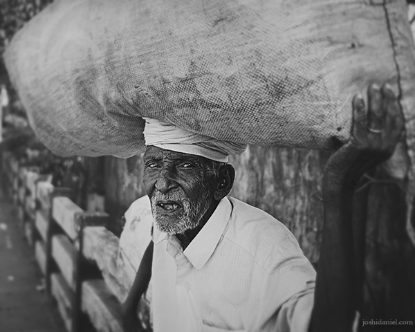 Old man in Trivandrum carrying a big load on his head